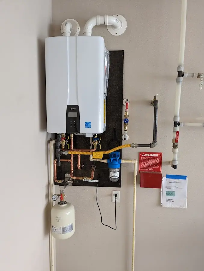 Professional plumber installing copper piping in a Pendleton home